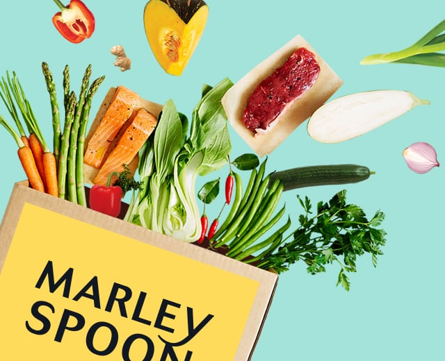 Marley Spoon meal kit with fresh ingredients flying out the box